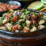 a wooden bowl filled with food on top of a table